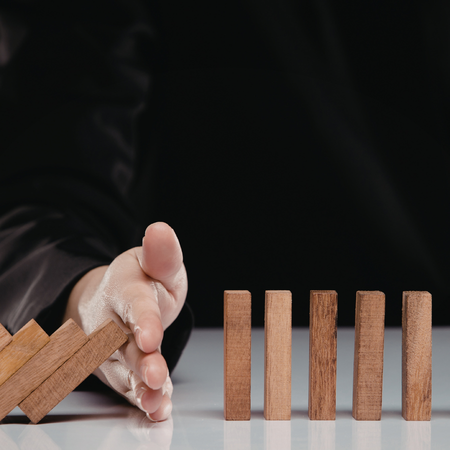 Hand stopping falling blocks indicating prevention
